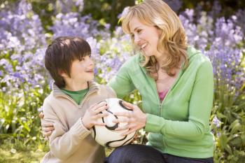 Royalty Free Photo of a Mother and Son Holding a Soccer Ball