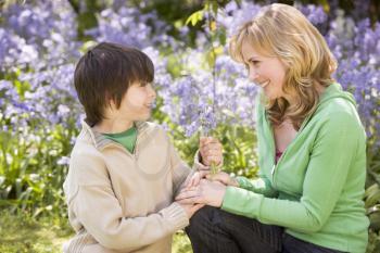 Royalty Free Photo of a Mother and Son Holding Flowers