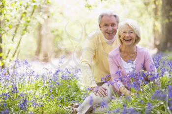 Royalty Free Photo of a Couple Sitting in a Field of Flowers