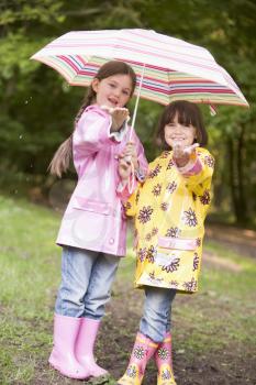 Royalty Free Photo of Two Little Girls With Umbrellas