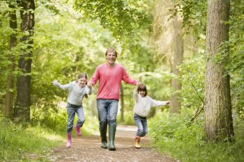 Royalty Free Photo of a Father and Daughters on a Trail