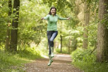 Royalty Free Photo of a Woman Jumping on a Path