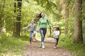 Royalty Free Photo of a Woman and Her Daughters on a Trail