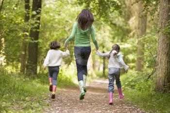 Royalty Free Photo of a Mother and Her Daughters on a Trail