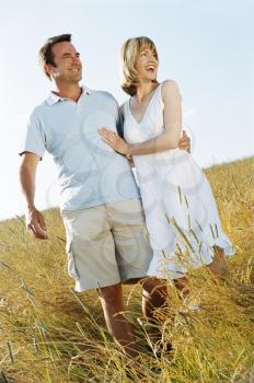 Royalty Free Photo of a Couple Standing in a Field