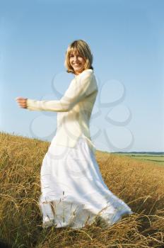 Royalty Free Photo of a Woman Dancing in a Field