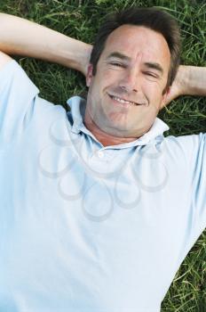Royalty Free Photo of a Man Lying On the Lawn
