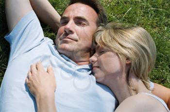 Royalty Free Photo of a Couple Sleeping on the Lawn