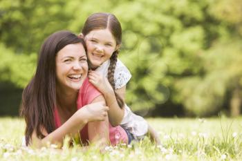 Royalty Free Photo of a Mother and Daughter in the Grass