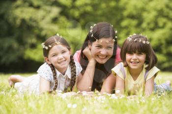Royalty Free Photo of a Mother and Daughters Wearing Daisy Chains