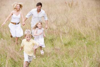 Royalty Free Photo of a Family Running Outside