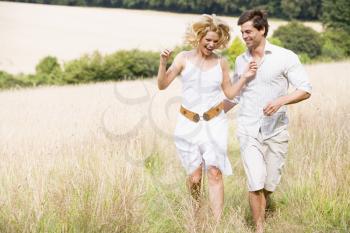 Royalty Free Photo of a Couple Running Outside