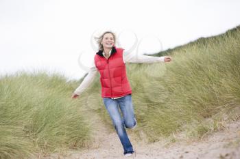 Royalty Free Photo of a Woman Running on Sand Dunes