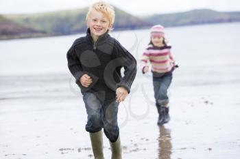 Royalty Free Photo of Two Children Running on the Beach