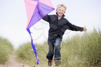 Royalty Free Photo of a Boy Running With a Kite