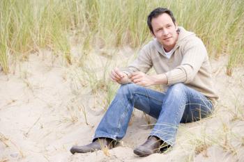 Royalty Free Photo of a Man Sitting at the Beach
