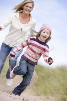 Royalty Free Photo of a Mother and Daughter Running at the Beach