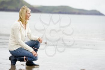 Royalty Free Photo of a Woman Crouching at the Water