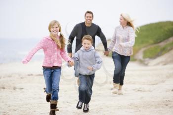 Royalty Free Photo of a Family Running on the Beach