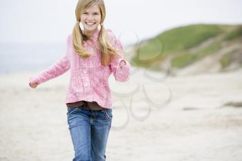 Royalty Free Photo of a Young Girl Running on the Beach