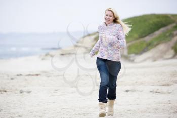 Royalty Free Photo of a Woman Running on the Beach