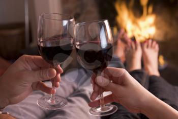 Royalty Free Photo of Two People Having Wine by the Fire