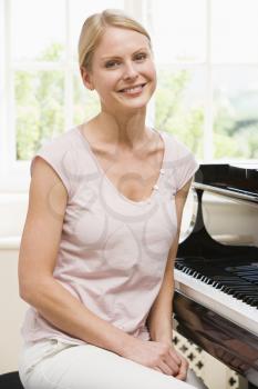 Royalty Free Photo of a Woman Sitting at the Piano