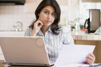 Royalty Free Photo of a Woman Paying Bills at the Laptop