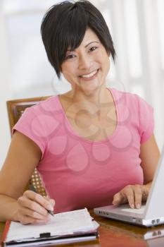 Royalty Free Photo of a Woman Doing Books With the Laptop
