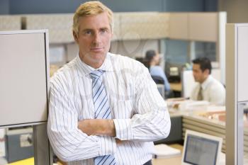 Royalty Free Photo of a Man Standing in an Office Cubicle