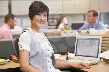 Royalty Free Photo of an Asian Woman in an Office Cubicle