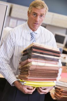 Royalty Free Photo of a Man With a Stack of Files