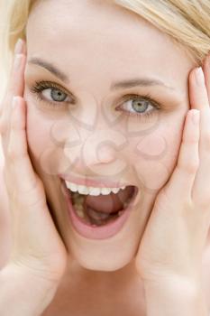 Royalty Free Photo of a Woman With Her Hands at Her Face