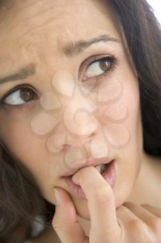 Royalty Free Photo of a Woman With Her Finger in Her Mouth