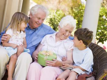 Royalty Free Photo of Grandparents With Grandchildren on a Patio