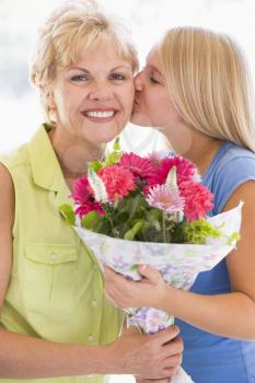 Royalty Free Photo of a Girl Giving a Woman Flowers