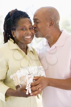 Royalty Free Photo of a Man Giving His Wife a Gift