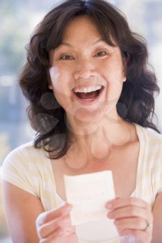 Royalty Free Photo of a Woman With a Winning Lottery Ticket