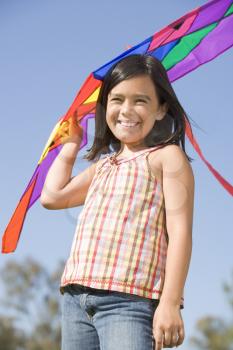 Royalty Free Photo of a Little Girl Outside With a Kite