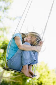 Royalty Free Photo of a Girl on a Swing