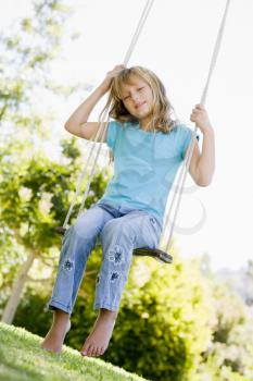 Royalty Free Photo of a Girl on a Swing
