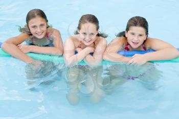 Royalty Free Photo of Three Girls at a Pool
