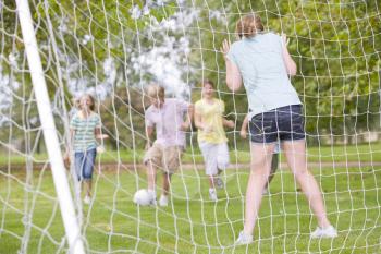 Royalty Free Photo of Kids Playing Soccer