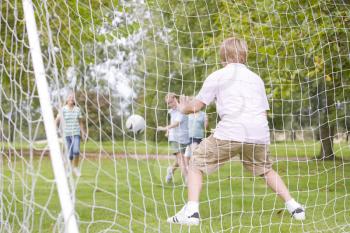 Royalty Free Photo of Kids Playing Soccer