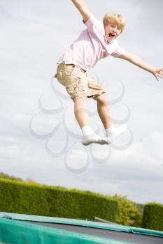 Royalty Free Photo of a Young Boy on a Trampoline