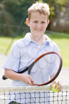 Royalty Free Photo of a Boy With a Tennis Racket