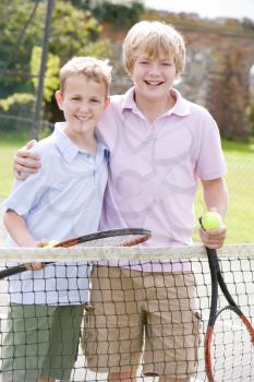Royalty Free Photo of Two Boys on a Tennis Court