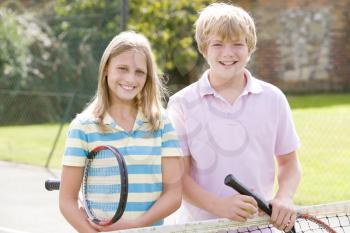 Royalty Free Photo of a Boy and Girl With Tennis Rackets