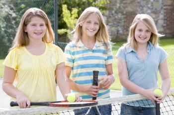 Royalty Free Photo of Three Girls on a Tennis Court