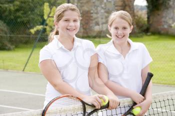 Royalty Free Photo of Two Girls on a Tennis Court